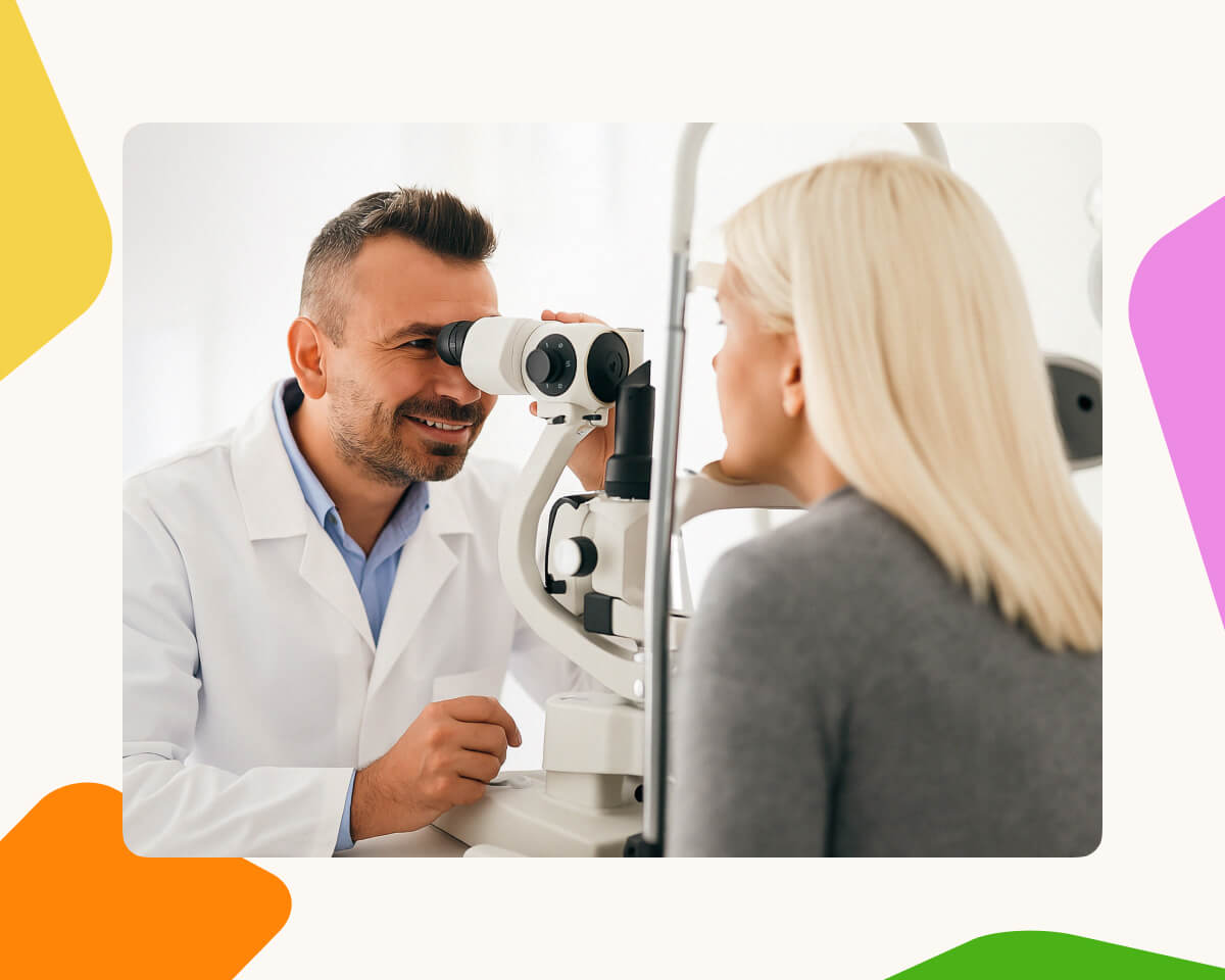 Optometrist examining an employee's eyes with a slit lamp